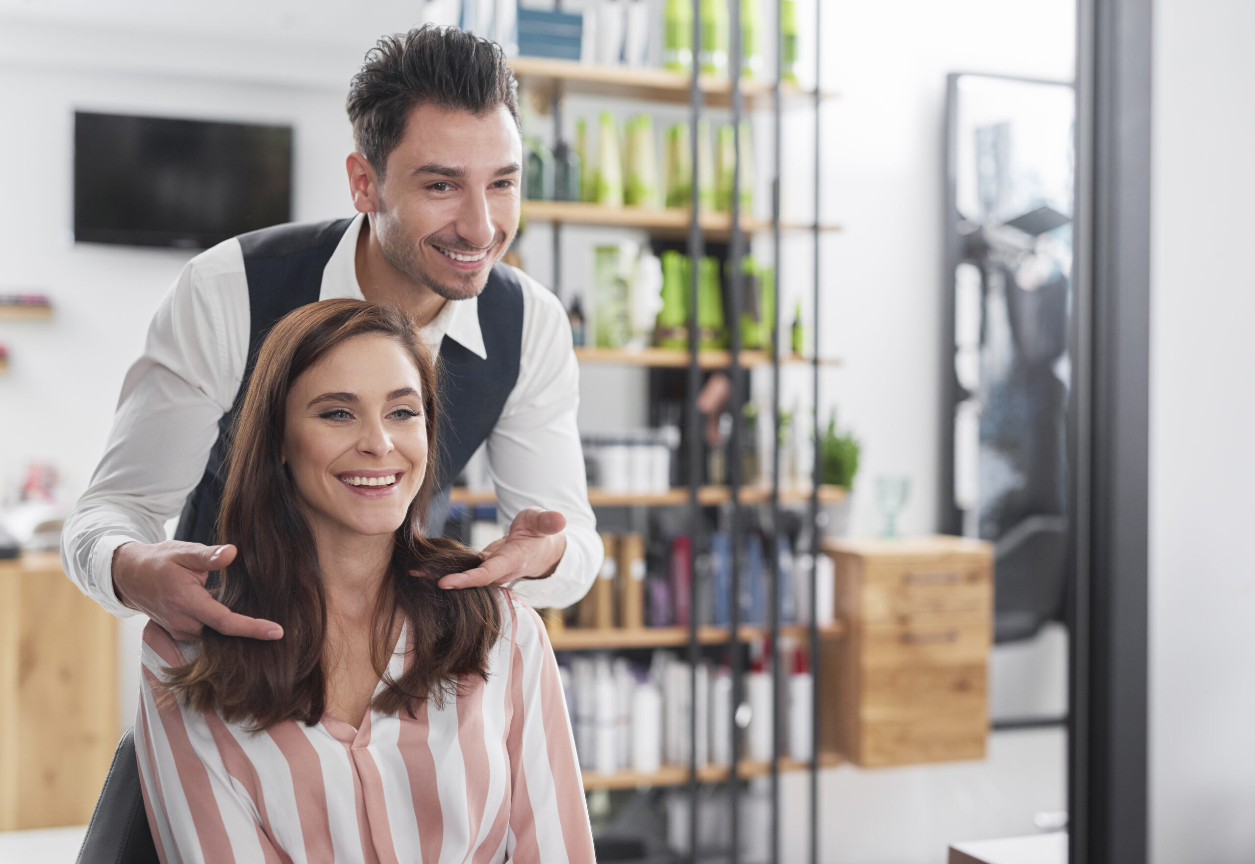 Hairstylist and female customer in hair salon