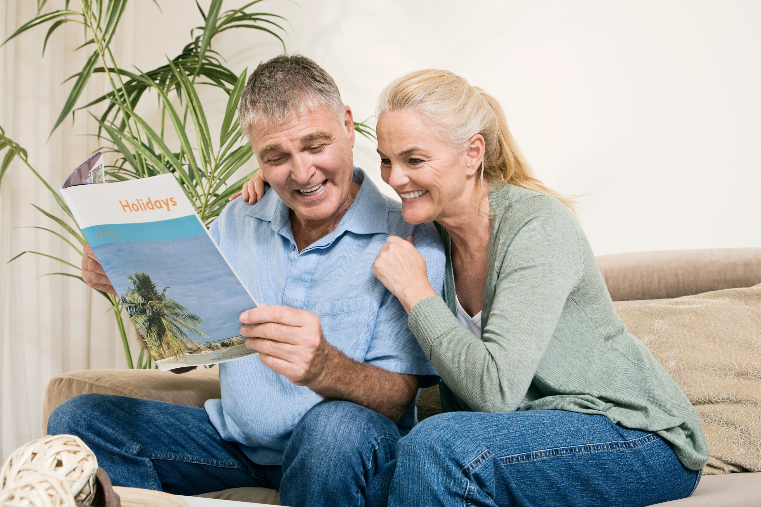 Mature couple with holiday brochure